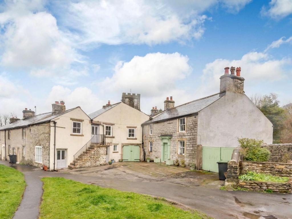 a row of old stone houses on a street at Lyndale House in Bradwell