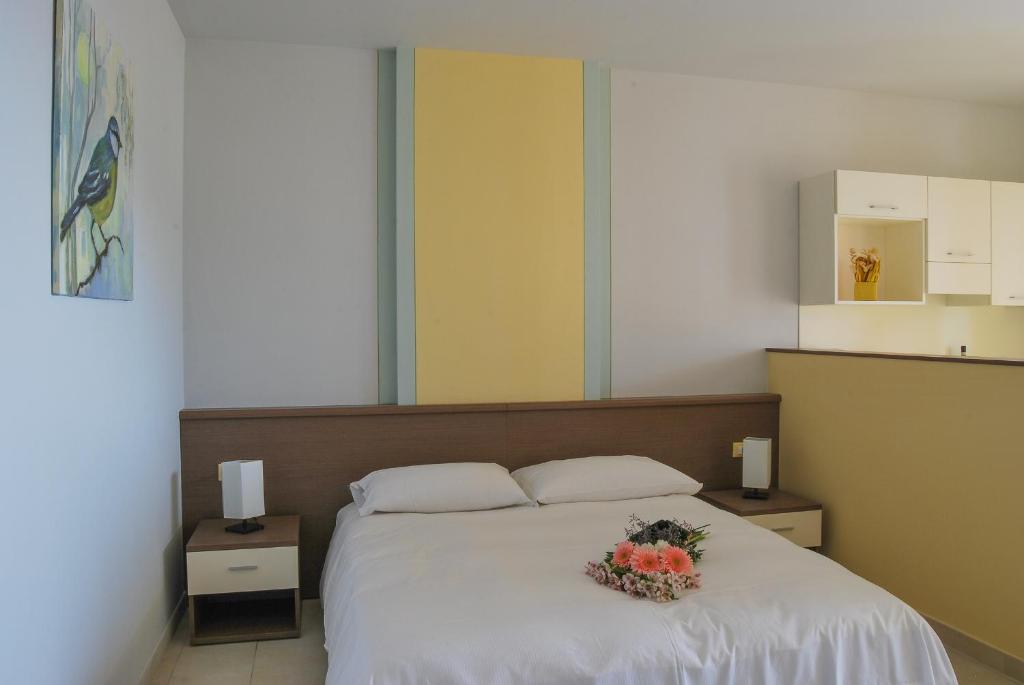 Ένα ή περισσότερα κρεβάτια σε δωμάτιο στο Residence Usignolo