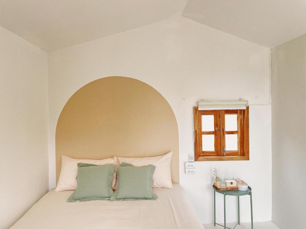 a bedroom with a bed with an arch above it at Monko Mini room in Pai