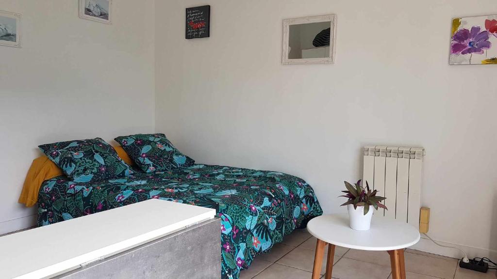 Kleines Zimmer mit einem Bett und einem Tisch in der Unterkunft kerfany in Locmiquélic