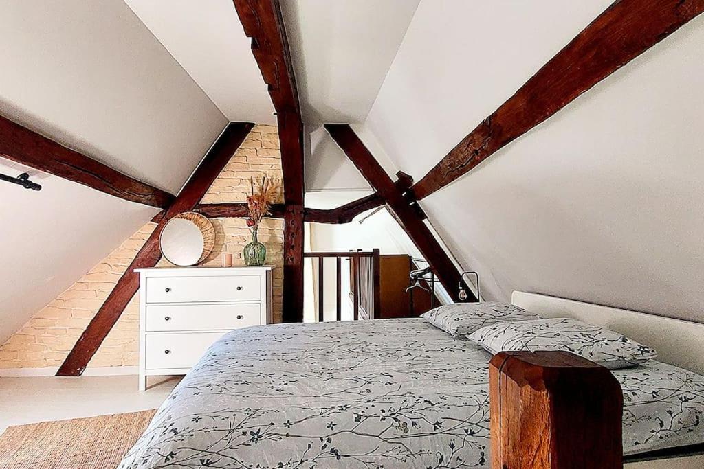 a bedroom with a bed and a dresser in a attic at Maisonnette in La Croix-en-Touraine