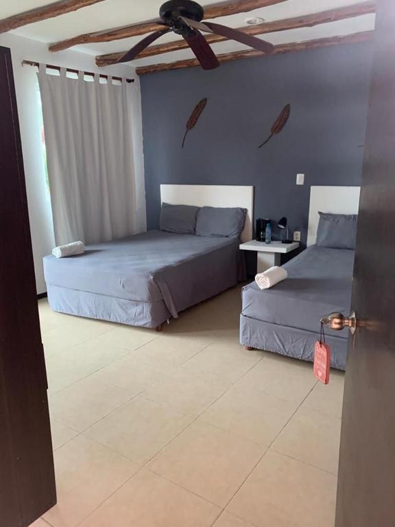 Postel nebo postele na pokoji v ubytování Hotel Arenas Mahahual