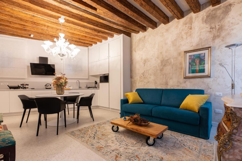 a living room with a blue couch and a table at "Ea casa de mì 2", l'incanto di vivere Venezia in Venice