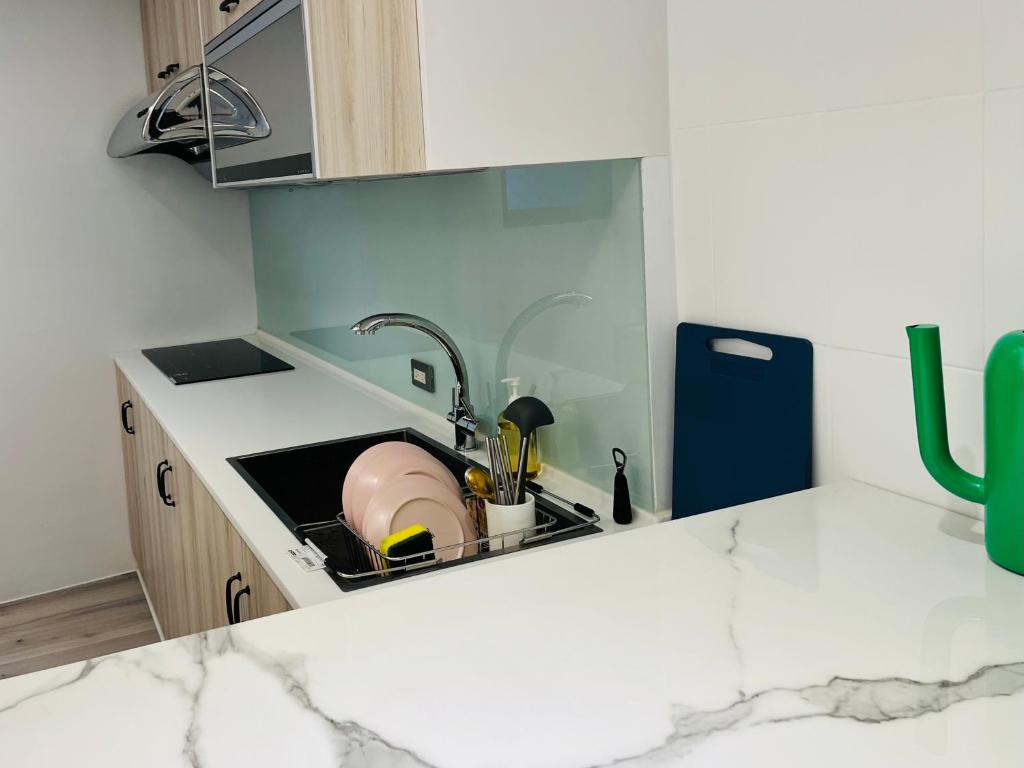 a kitchen counter with a sink in a kitchen at Inside the alley in Tainan