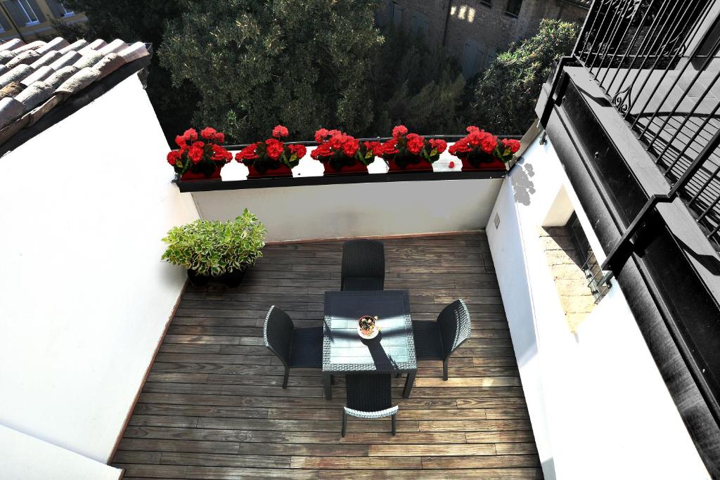 an overhead view of a balcony with a bench and flowers at Eulalia's House in Modena
