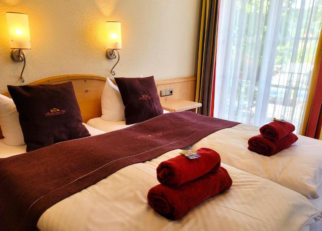 two towels on a bed in a hotel room at Hotel Alttolkewitzer Hof in Dresden