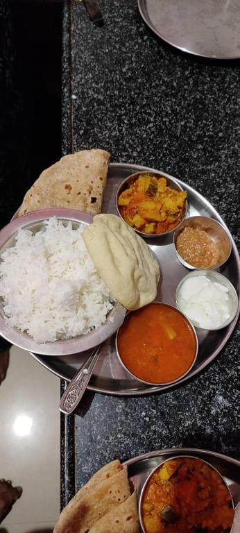 a tray of rice and other food on a counter at Mamatha Guest inn in Hampi