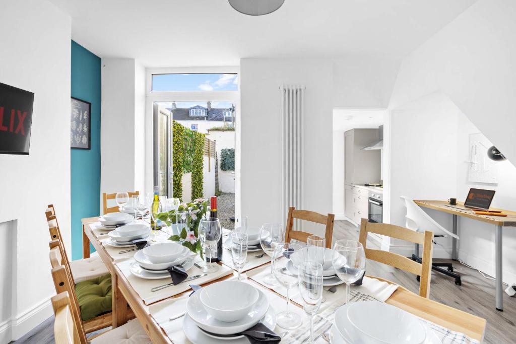 a white dining room with a table and chairs at Gloster Town House gorgeous family home Barnstaple in Barnstaple