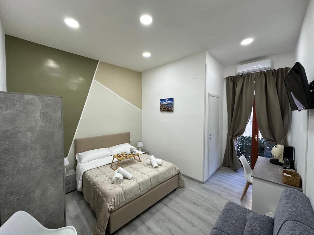 a bedroom with a bed and a living room at Garibaldi guest house in Naples