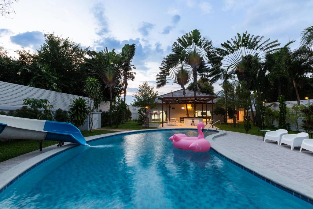 a swimming pool with a pink rubber duck in the middle at Houses of Sunny in Bang Sare