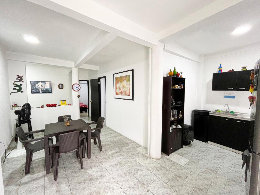 a dining room with a table and chairs and a television at Miss Yasmin Place in San Andrés