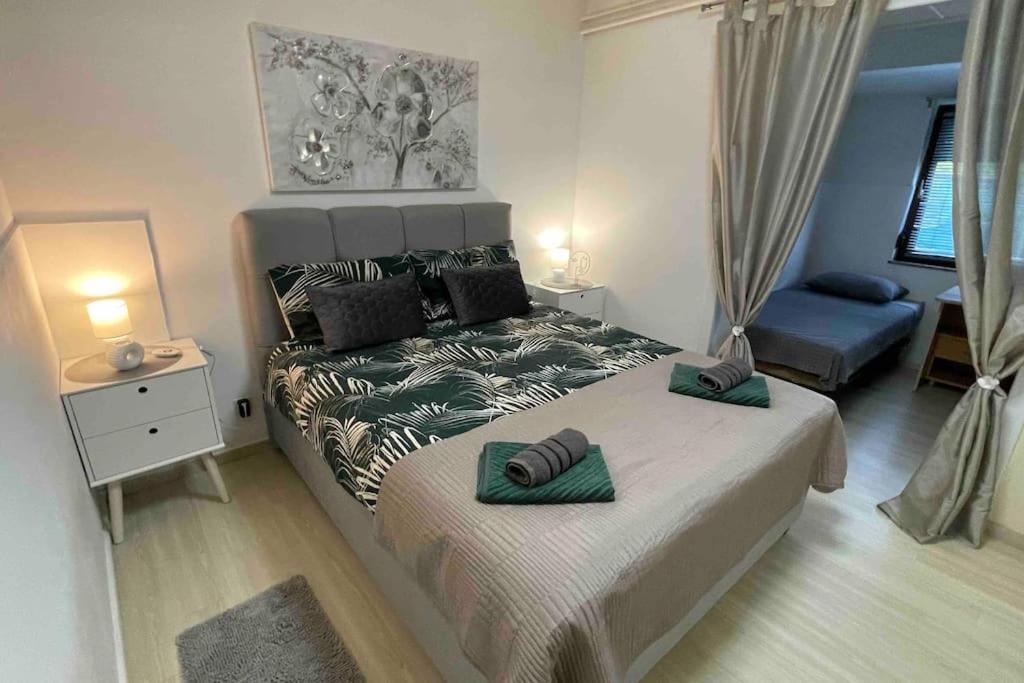 a bedroom with a bed with two pillows on it at Lux apartment Barbara with Jacuzzi in Poreč