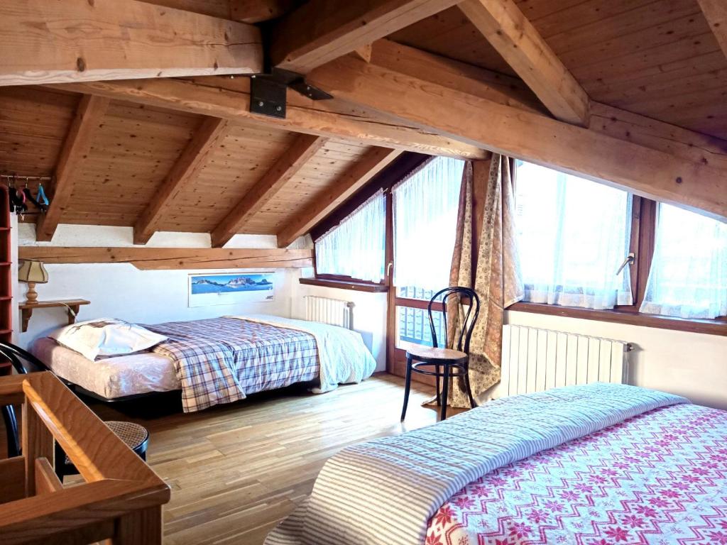 Säng eller sängar i ett rum på Casa Rosetta nel cuore delle Dolomiti