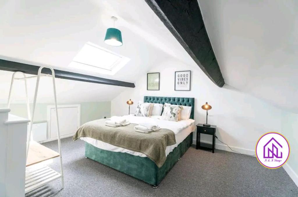 a bedroom with a large bed in a attic at Havelock Apartments, City Centre Location in Swindon