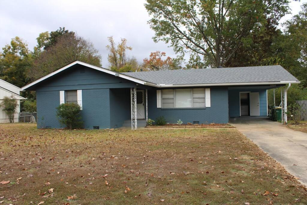 a blue house with a yard in front of it at Birchwood Place in Little Rock