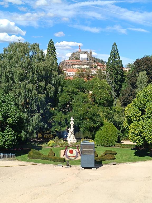 a view of a park with a building in the background at La ch&#39;tiote meizou in Mazet-Saint-Voy