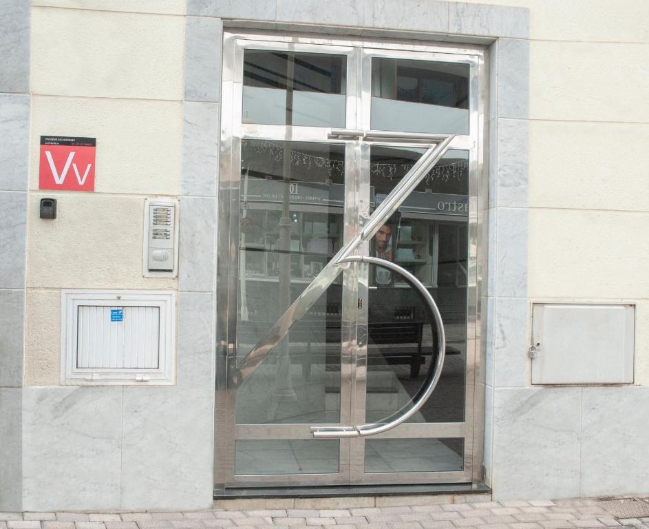 a glass door of a building with a sign on it at VV - La Plazuela in Arrecife