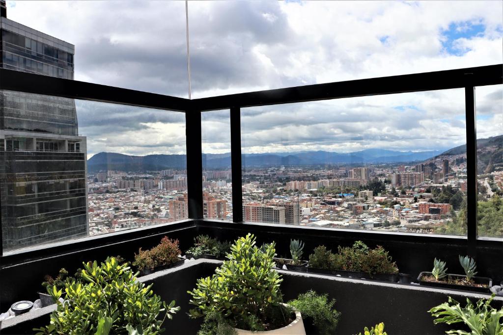 a view of a city from the top of a building at Aparta Estudio Norte Bogotá in Bogotá