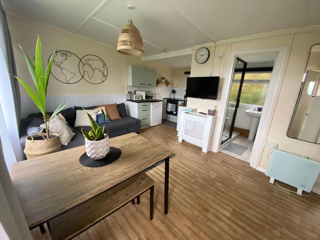 a living room with a table and a couch at Bay view chalet, 28 Sea Valley in Bucks Mills