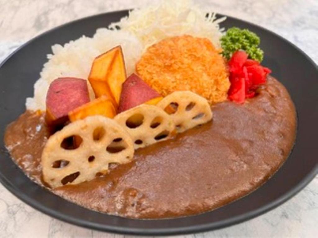 a plate of food with meat and vegetables and rice at Dormy Inn Kanazawa Natural Hot Spring in Kanazawa