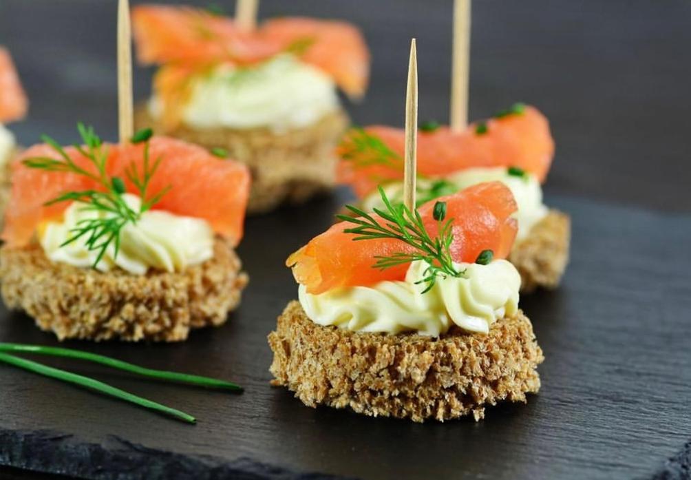 a group of small sandwiches with seafood on them at Hotel Active Stadium in Lovosice