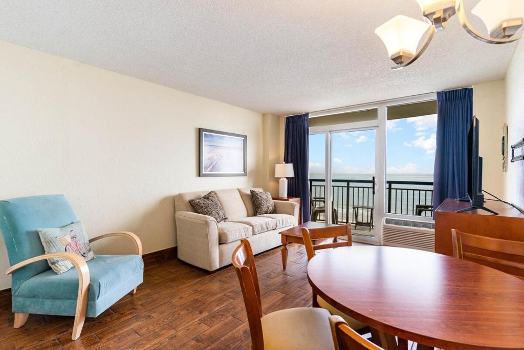 a living room with a table and a couch at Oceanfront 1BR, Downtown, 4ppl in Myrtle Beach