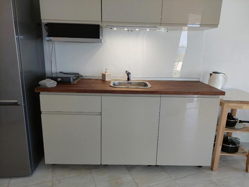 a kitchen with a sink and a wooden counter top at Seaview dreams in Ormos Panagias