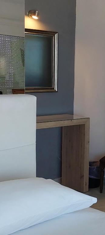 a bedroom with a bed and a table with a television at Seaview dreams in Ormos Panagias