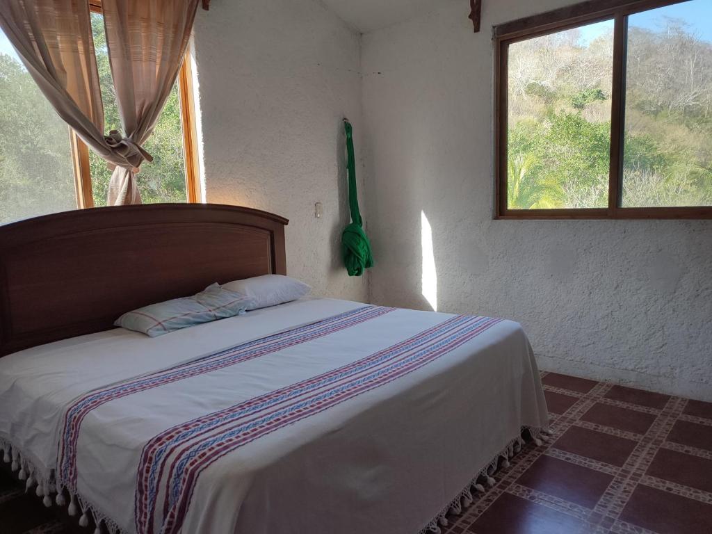 1 dormitorio con 1 cama en una habitación con ventana en Casa Galaa Guiba', en Tangolunda