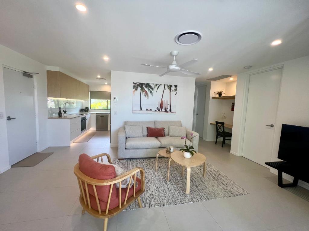 a living room with a couch and a table at NEW - Sunny Coolum Beach Retreat in Coolum Beach