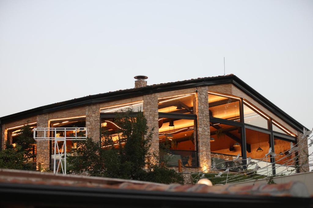 une maison avec de grandes baies vitrées dans l'établissement Flumen Park, à Tirana