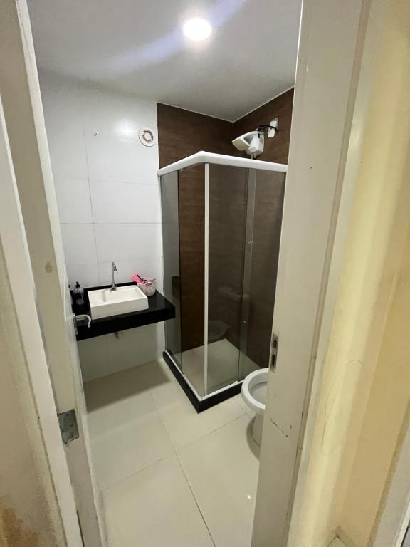 a small bathroom with a toilet and a sink at Quarto luxo barra da Tijuca in Rio de Janeiro