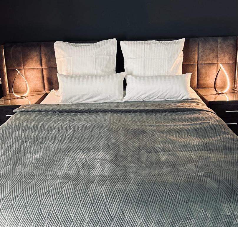 een bed met 2 kussens en een dekbed bij Firstclass Event & Hotel in Fürth