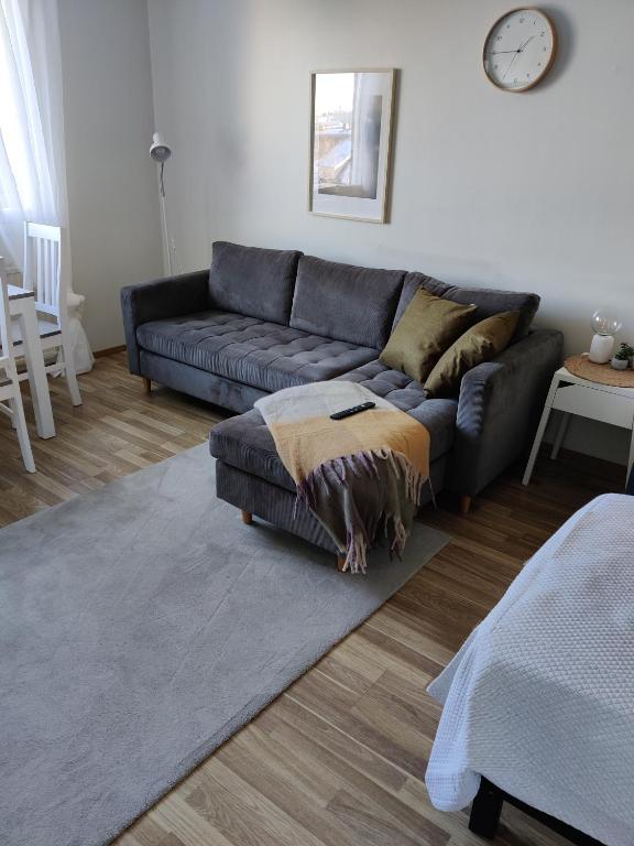 a living room with a couch and a rug at Hilla Apartments in Rovaniemi