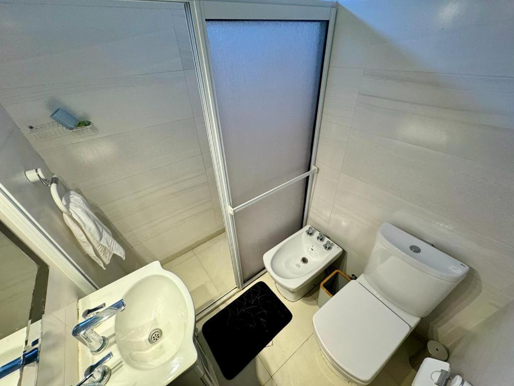 a small bathroom with a toilet and a sink at Casa con pileta cerca del Parque in Godoy Cruz