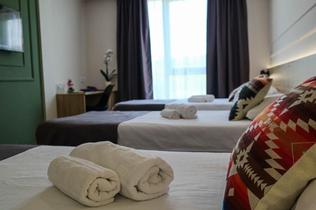 Postel nebo postele na pokoji v ubytování Hotel Dijana