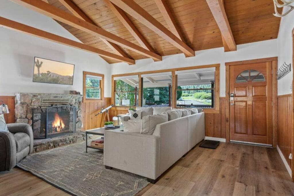 a living room with a couch and a fireplace at Base Camp New Ski Slope Views with HOT TUB. in Big Bear Lake