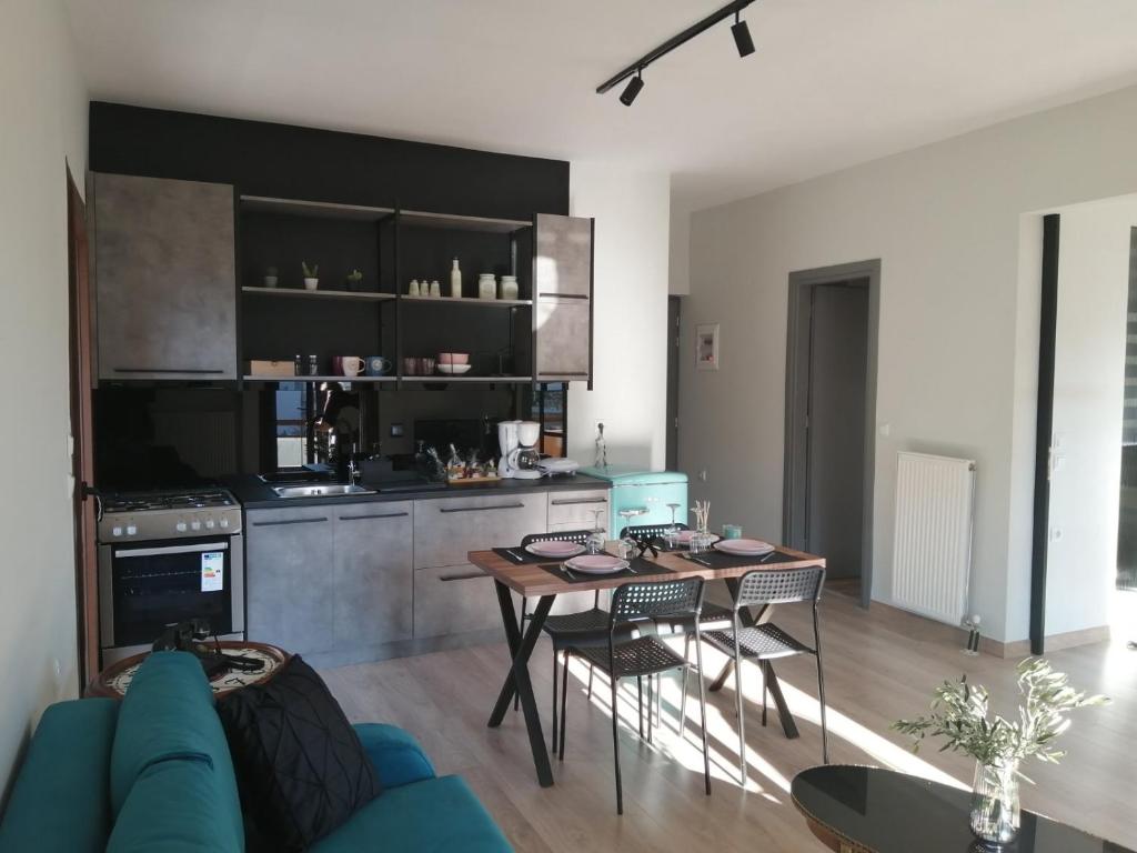 a living room with a table and a kitchen at Eleana in Ioannina