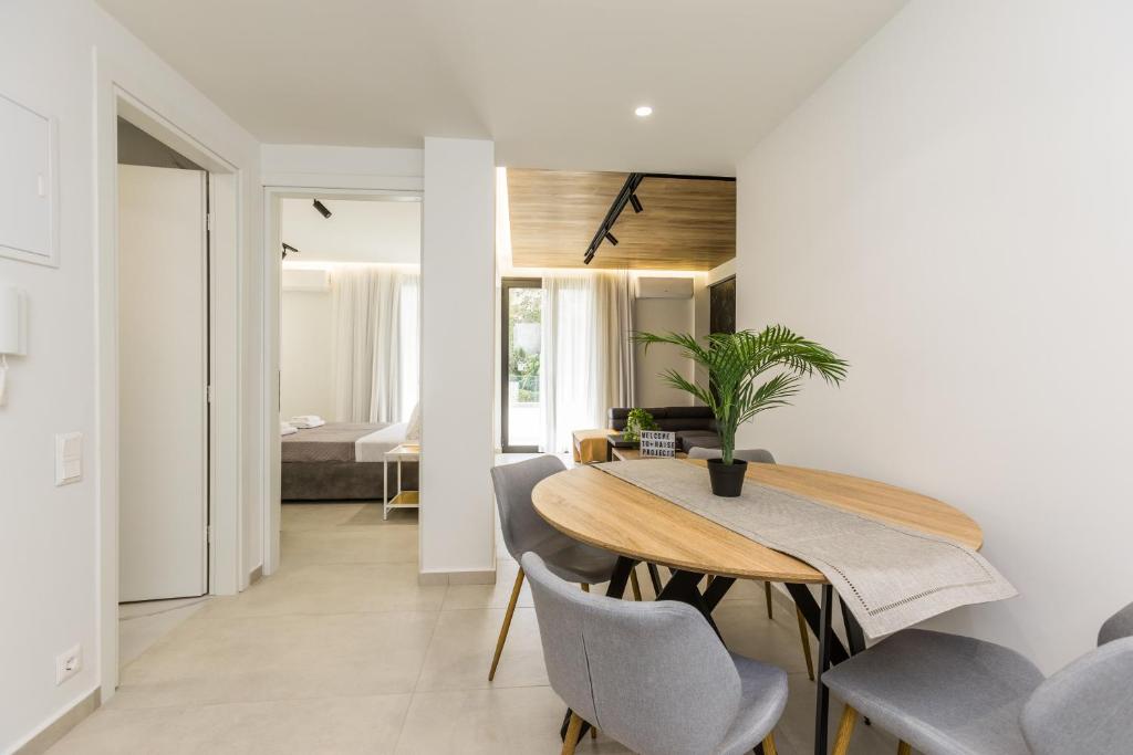a dining room and living room with a table and chairs at Varkiza Luxury Suites by Raise in Vari