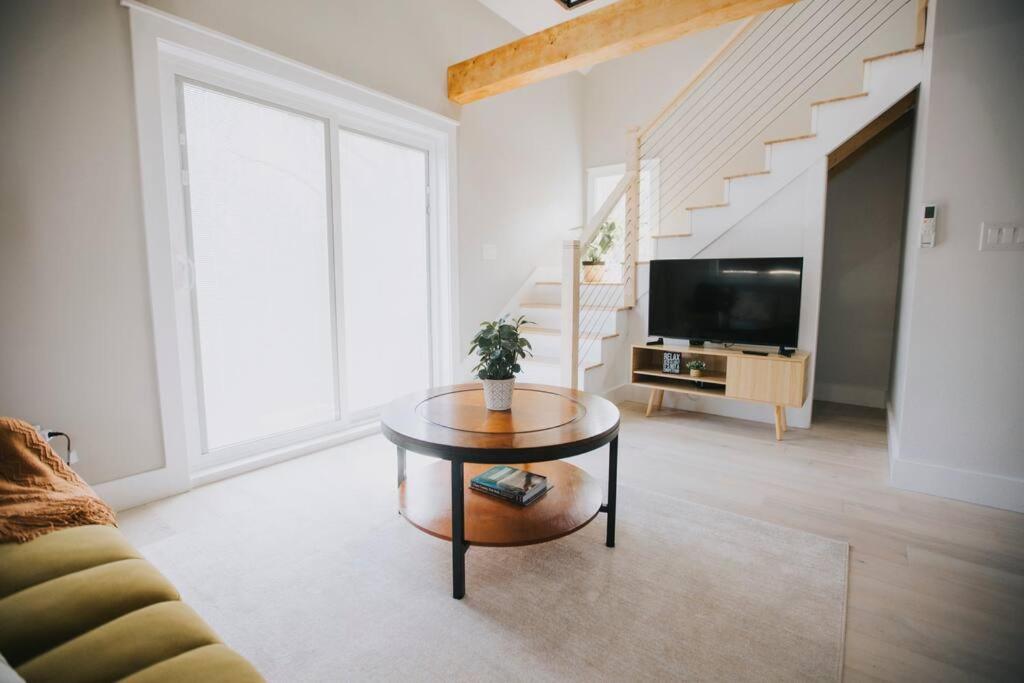 a living room with a table and a tv at Villa Costello, in Kingston