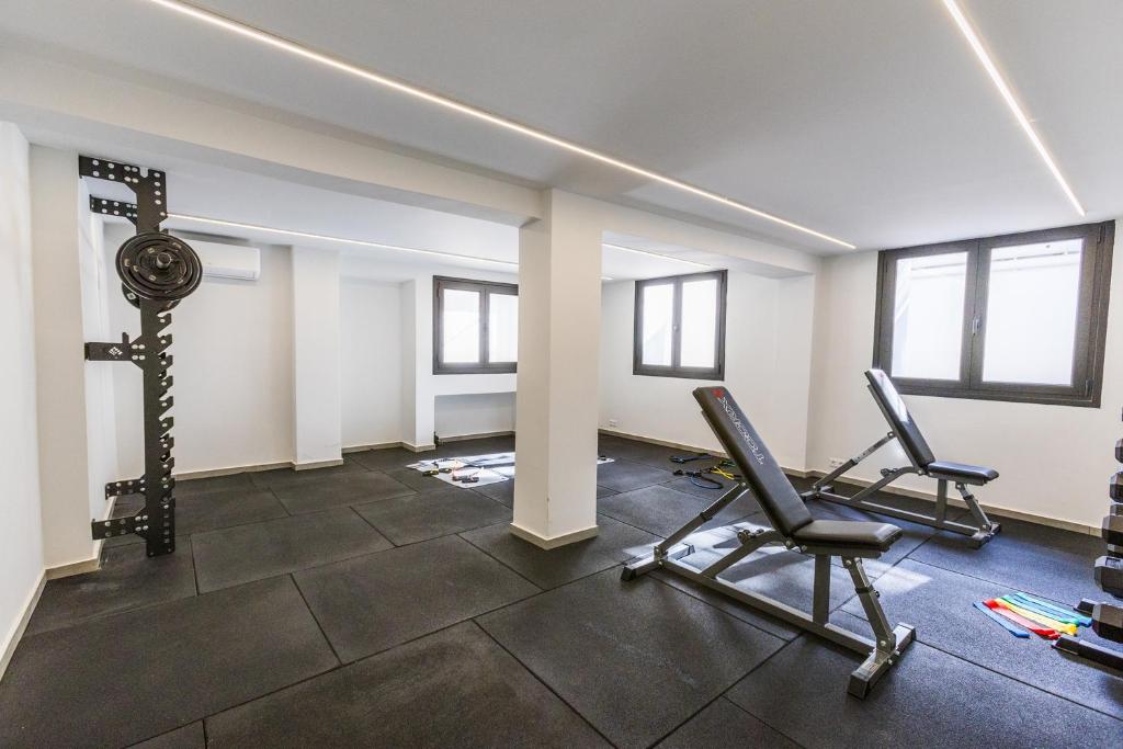 an empty room with a gym with two chairs at Varkiza Luxury Suites by Raise in Vari