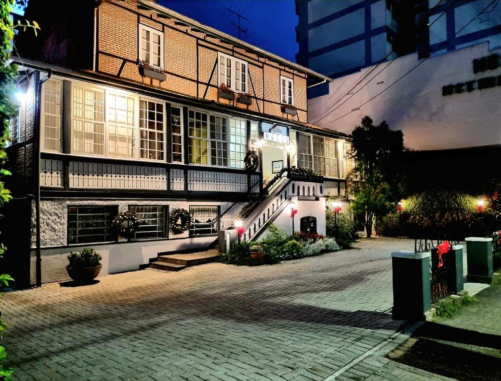 a building with a staircase in front of it at night at Hotel Hermann in Blumenau