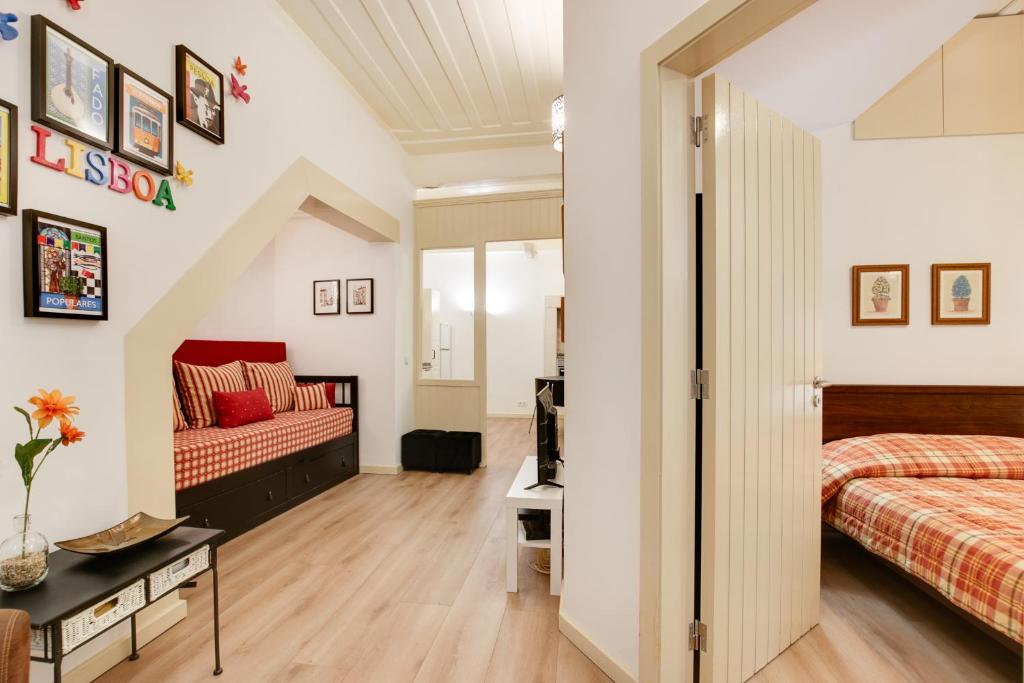 a bedroom with a bed and a couch at Charming New Apartment in the Heart of Lisbon in Lisbon