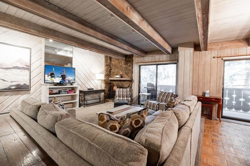 a living room with a couch and a table at Villa Cortina Condo Next to Vail Village in Vail