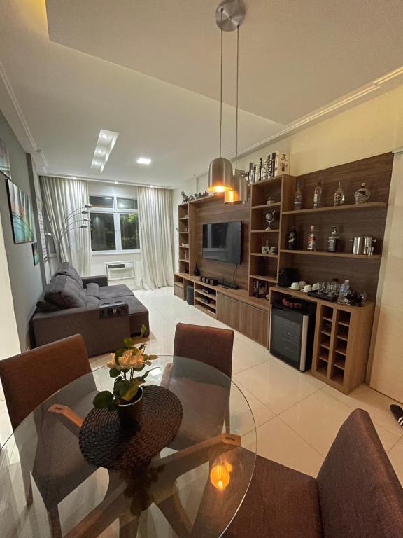 a living room with a glass table and chairs at Apartamento Copacabana Luxo in Rio de Janeiro