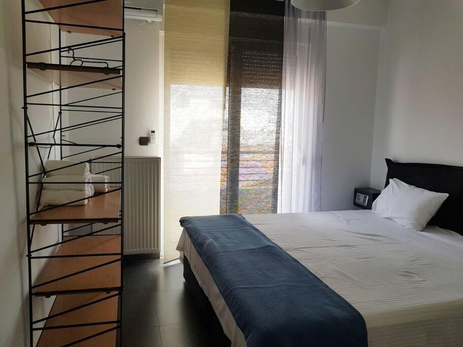 a bedroom with a bed and a spiral staircase at Cupola in Orestiada