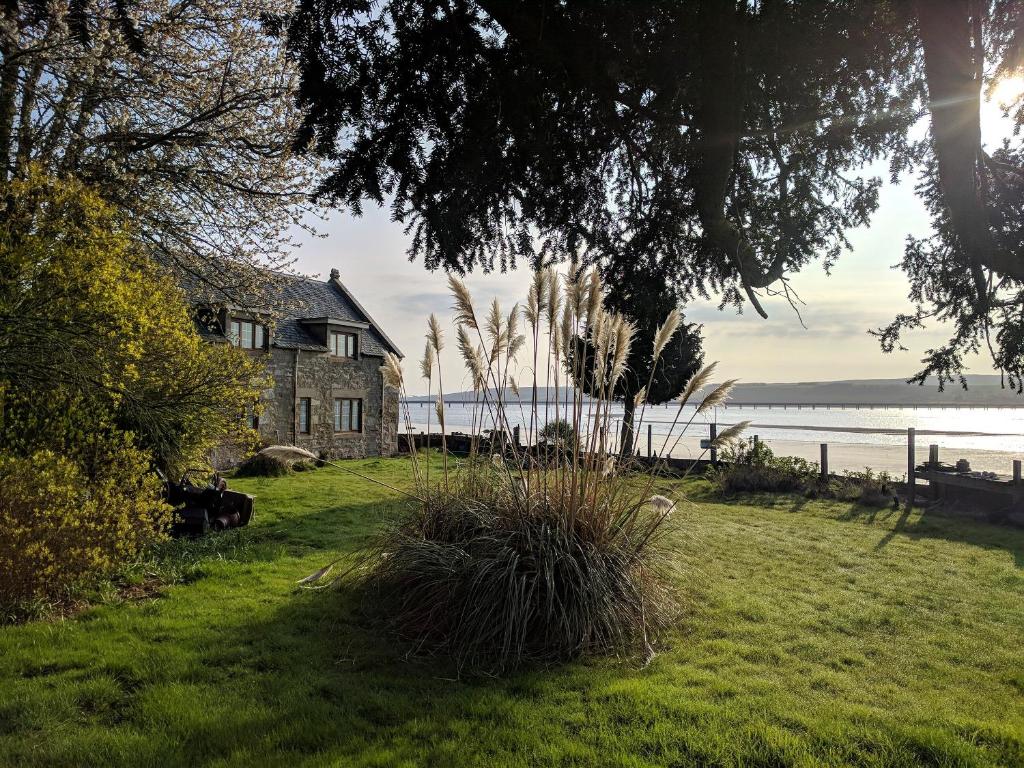 a house on the shore of a body of water at St Brighs in Dingwall