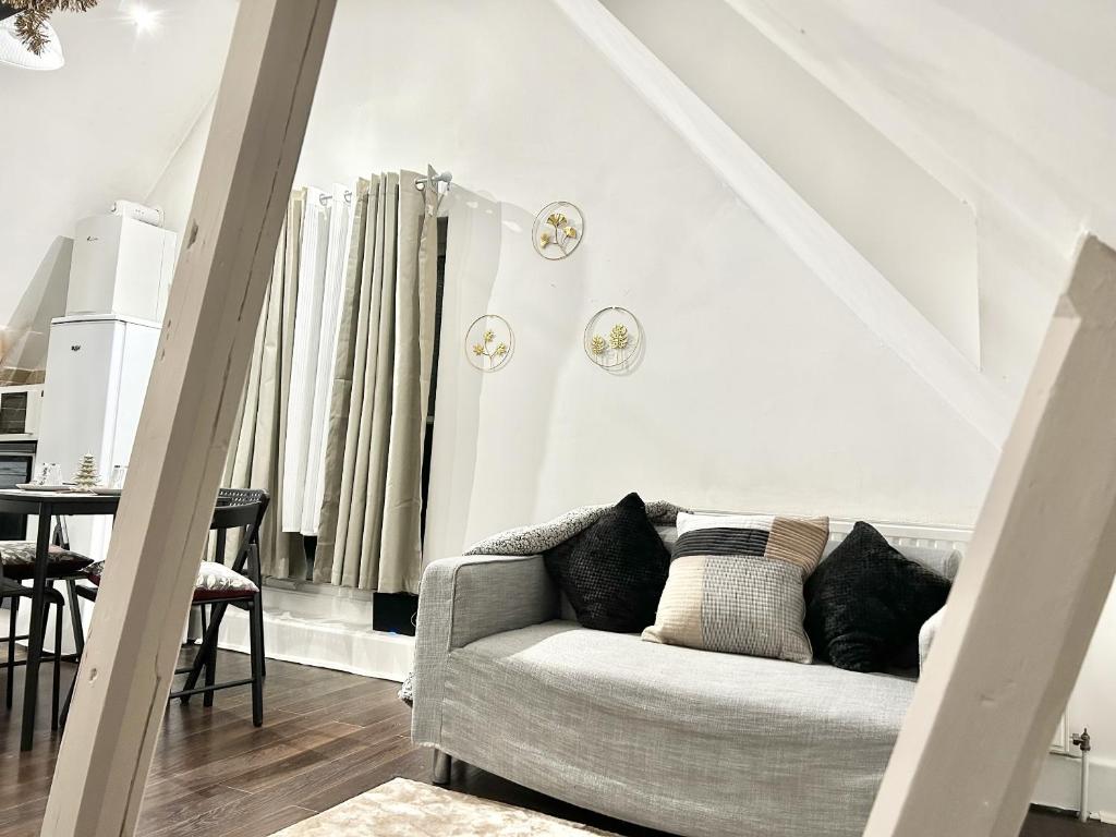 a white living room with a couch and a table at Gundulph house in Rochester