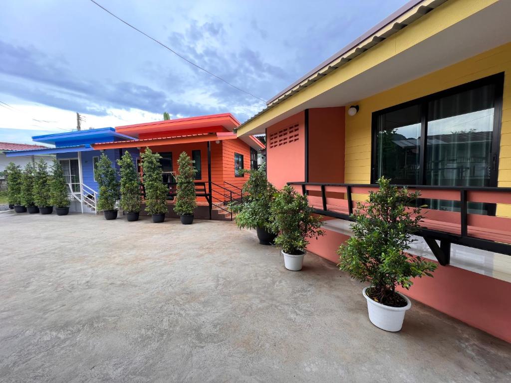 a row of houses with potted plants in front of them at Pada Guesthouse Khaoyai in Mu Si