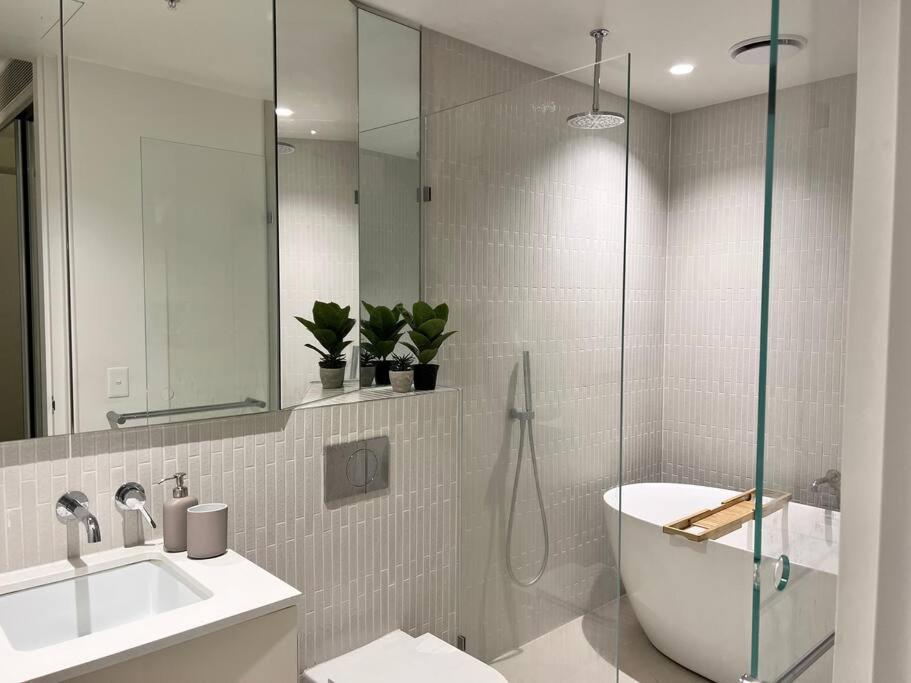 a bathroom with a shower and a sink and a toilet at Luxury 3 Bed 2 Bath + car park at Melbourne Square in Melbourne